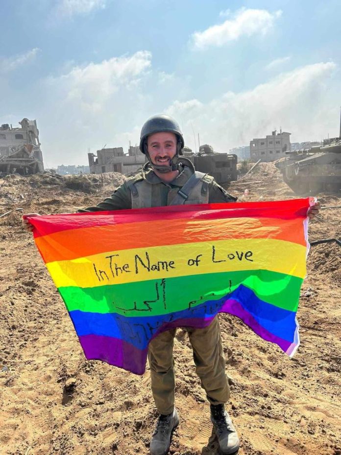 G@Y Israeli Soldier Proudly Displays LGBTQ Flag On Gaza Soil In War Against Hamas