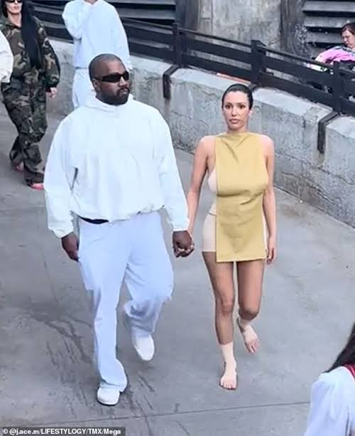 Bianca Censori goes BAREFOOT with Kanye West as they join the crowds ...